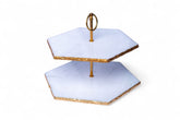 Two-tiered serving tray with gold accents on a white background