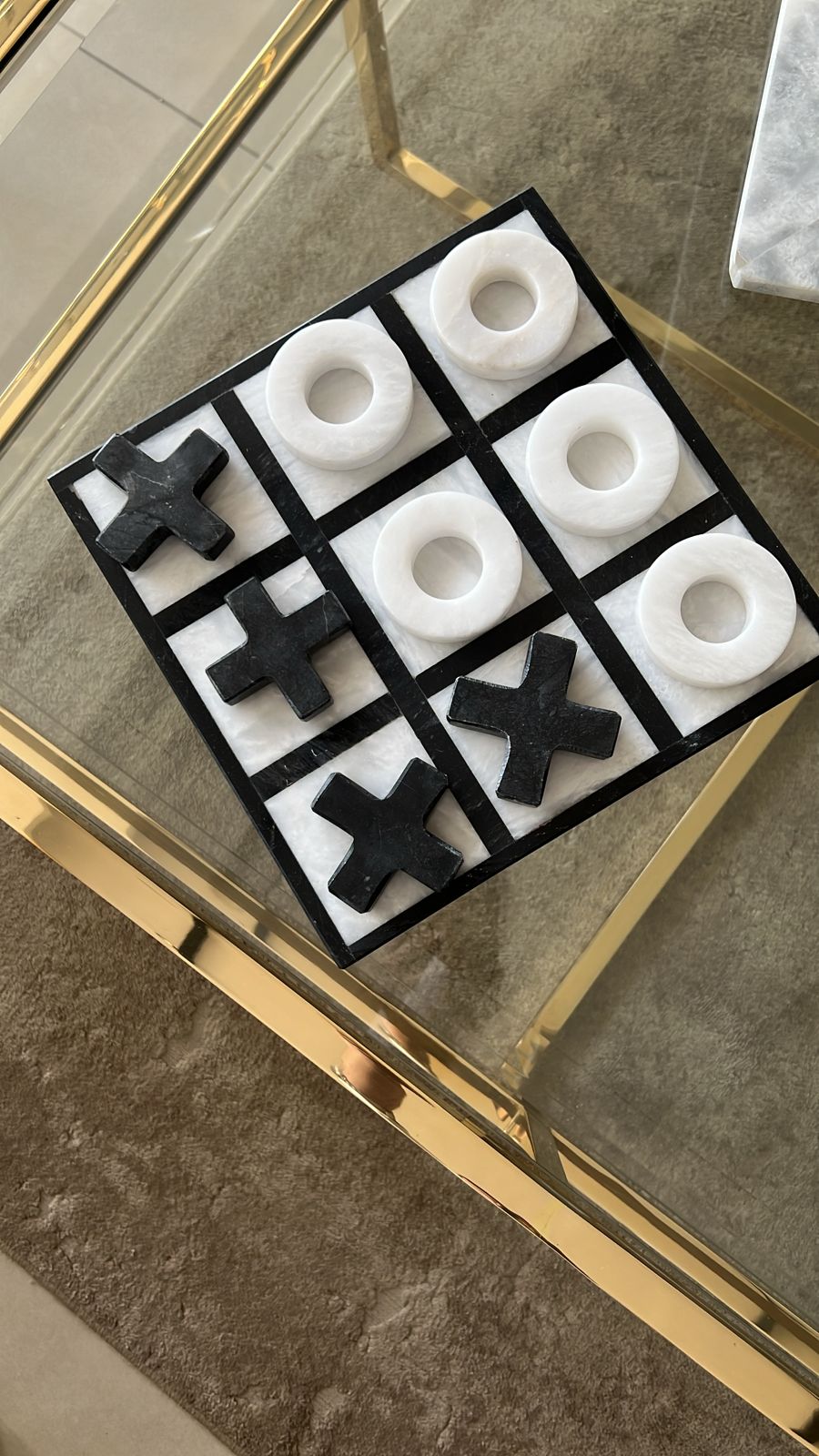 Noughts and crosses game set on a reflective surface