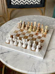 Marble chessboard with chess pieces on a marble table
