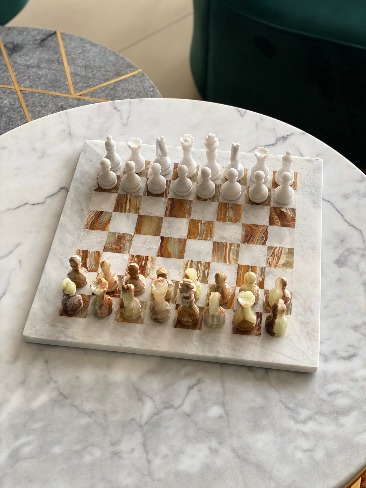 Marble chessboard with chess pieces on a marble surface