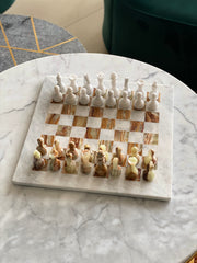 Marble chessboard with chess pieces on a marble surface
