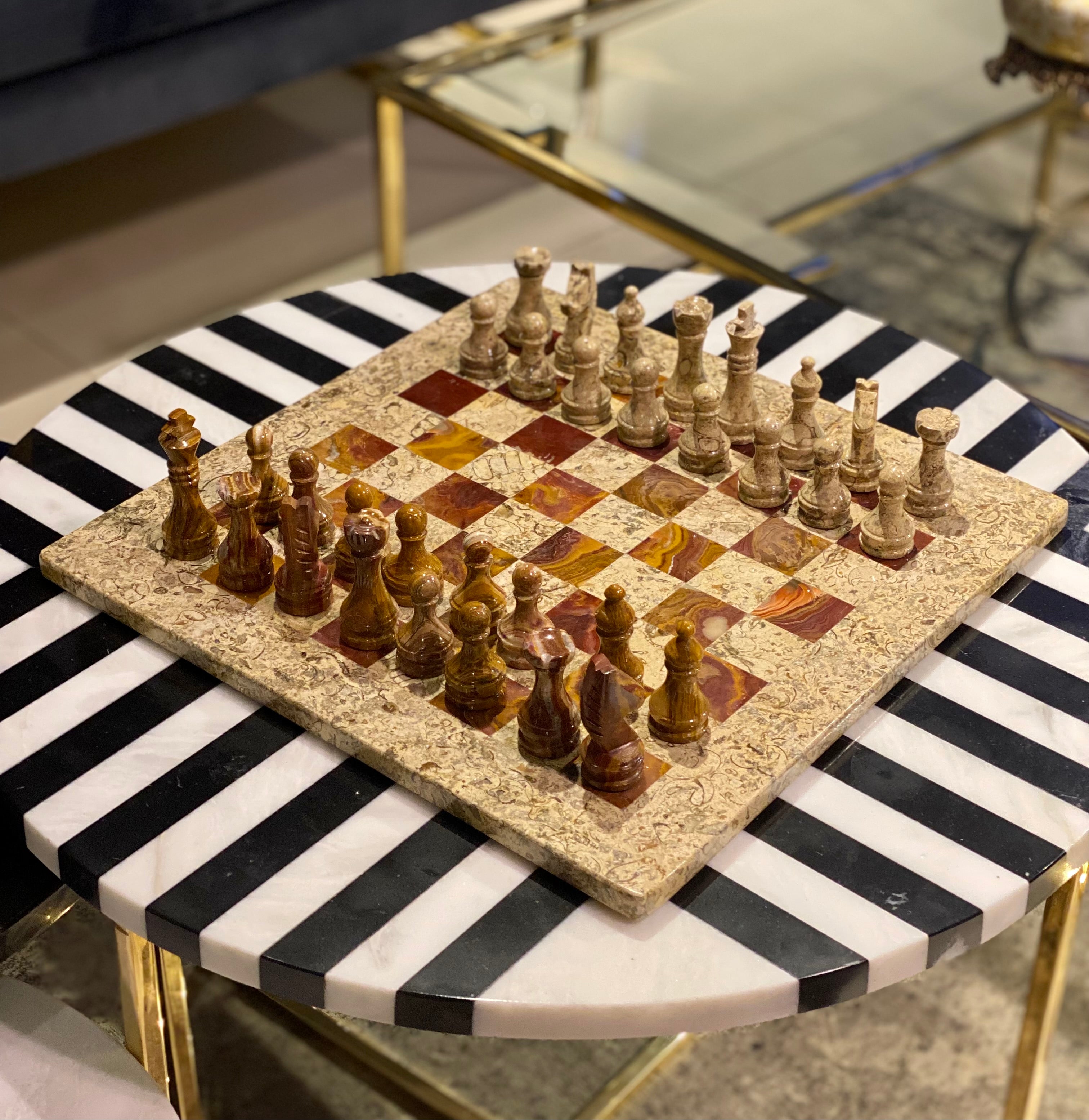 Chessboard with chess pieces on a black and white striped table