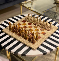Chessboard with chess pieces on a black and white striped table