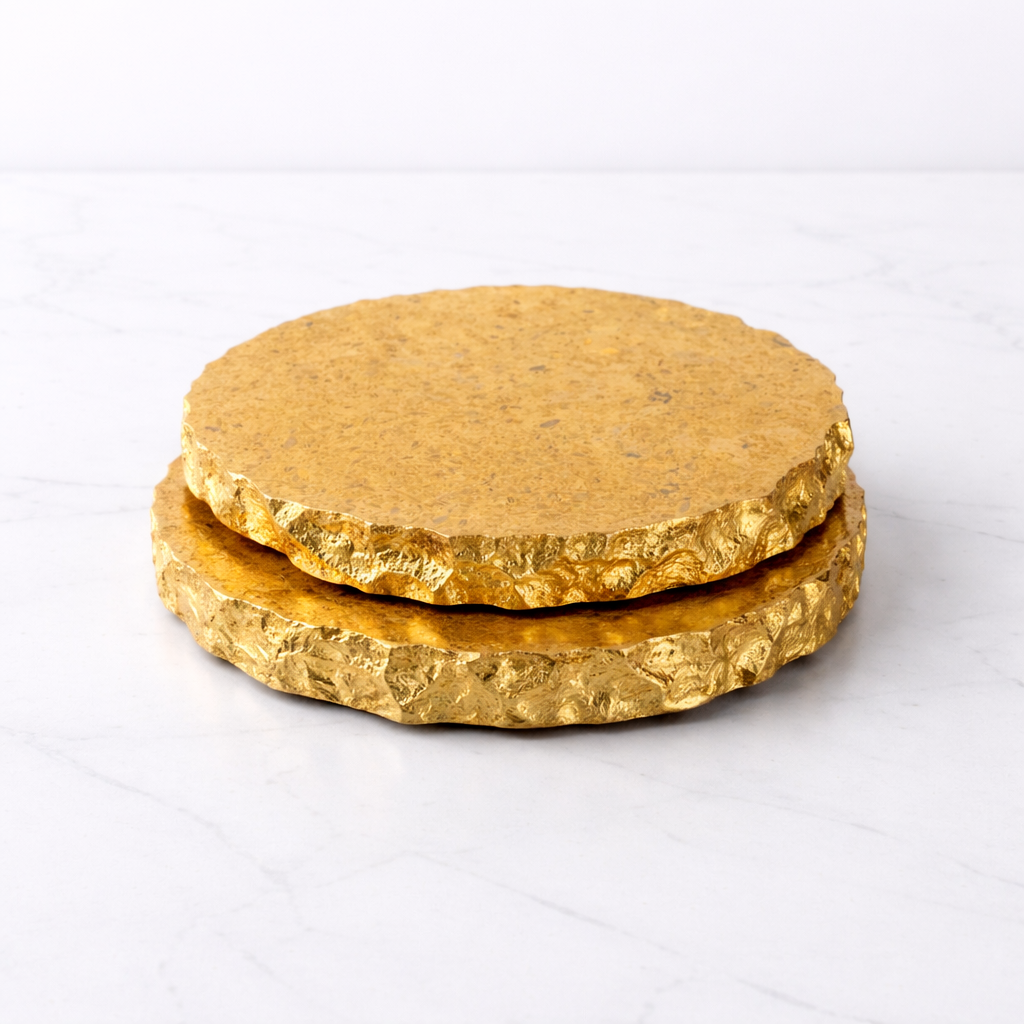 Two gold-colored round objects stacked on a white background