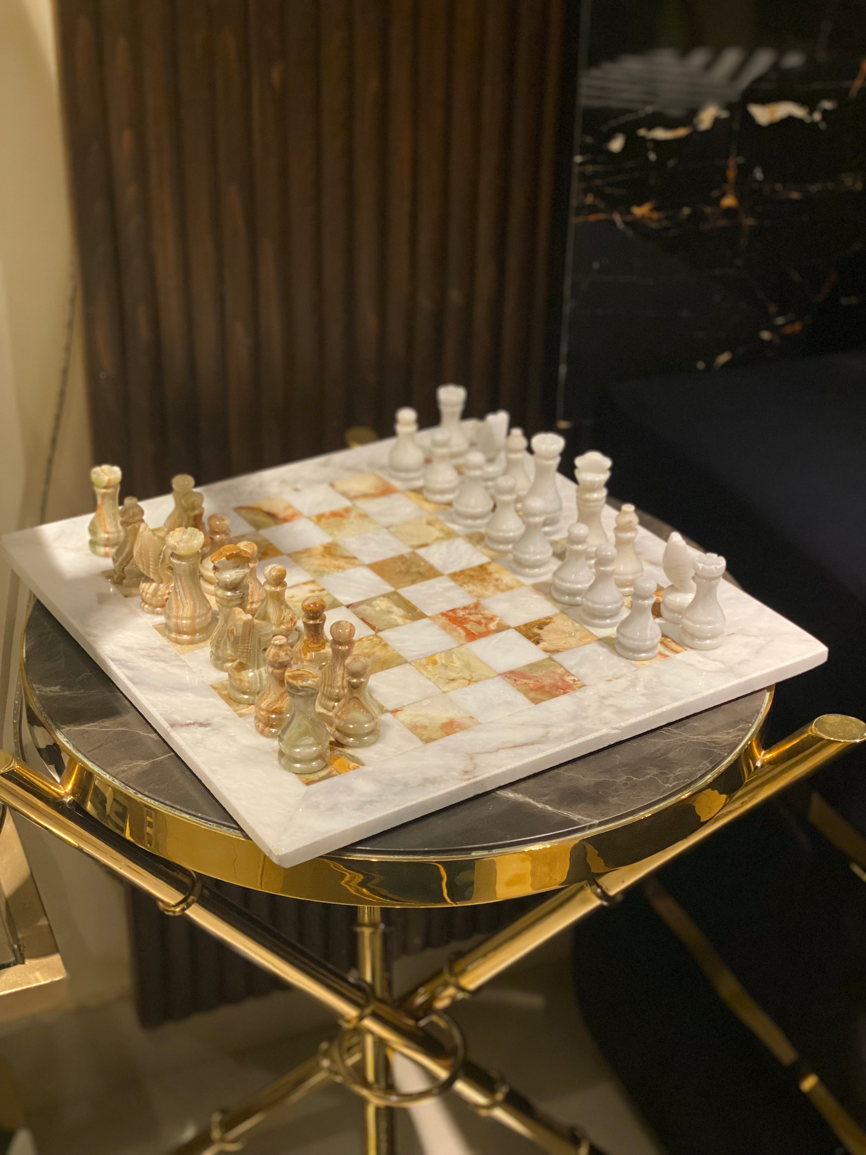 Marble chessboard with gold accents on a decorative table
