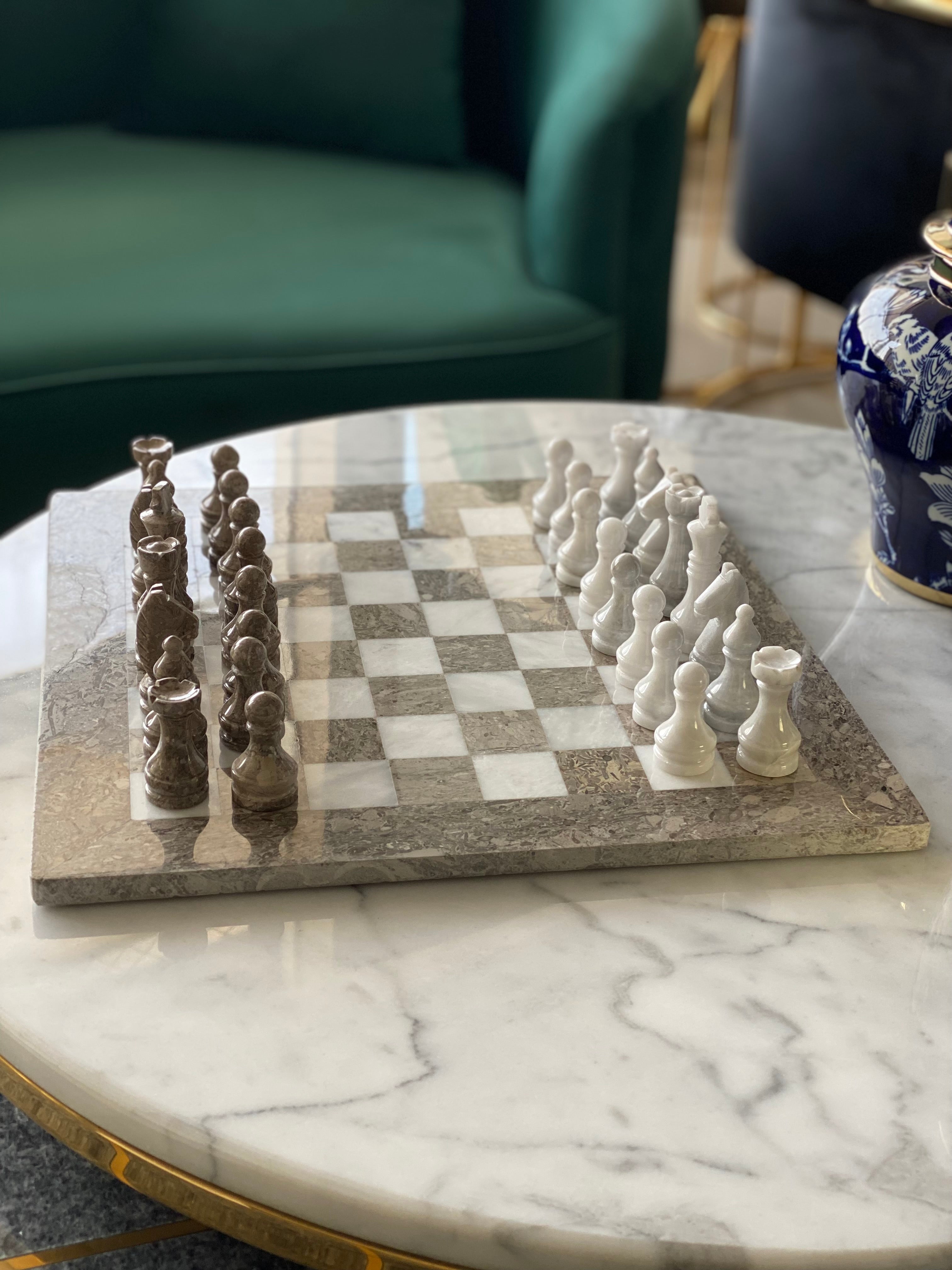 Chessboard with chess pieces on a marble table