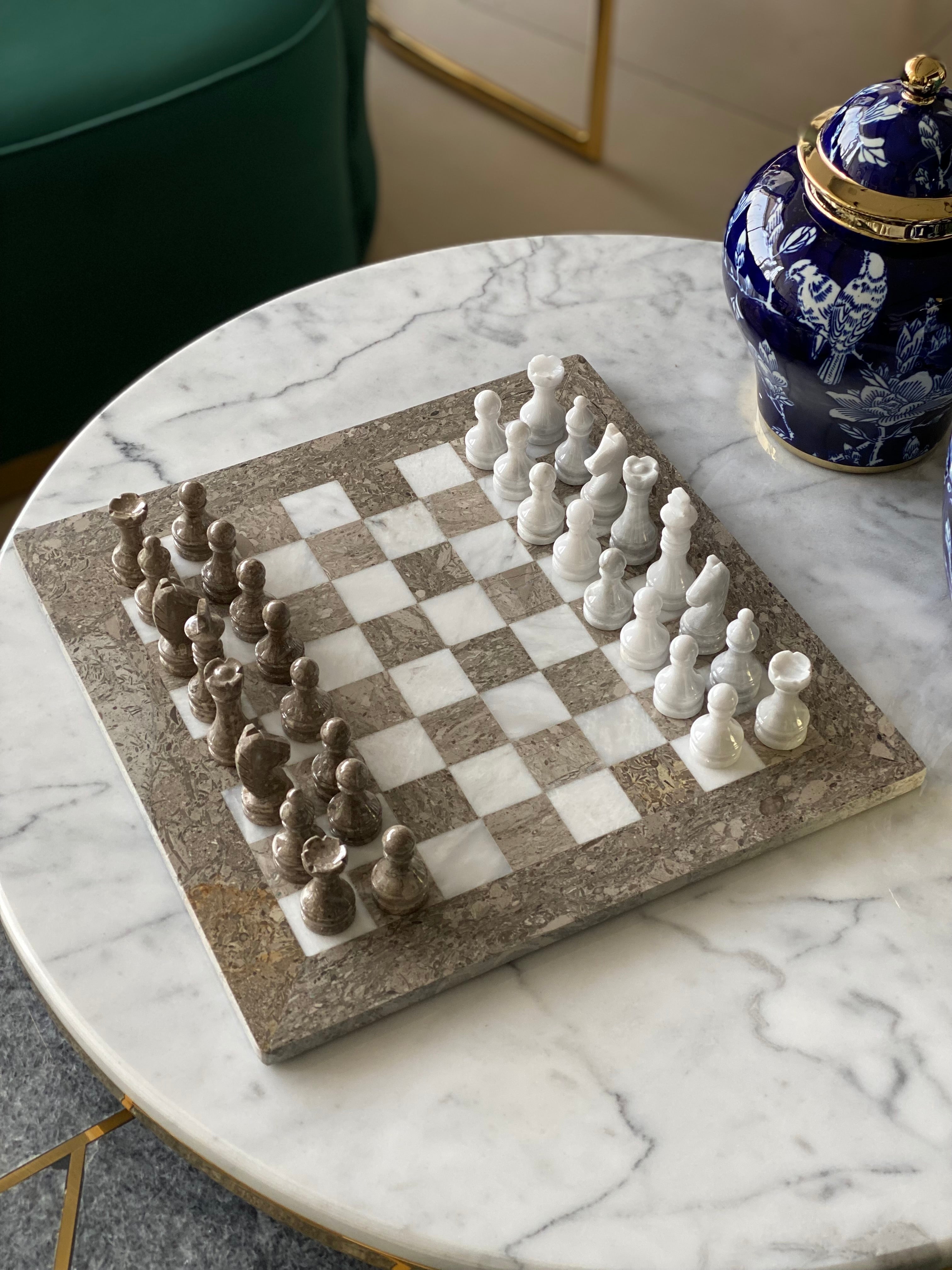 Marble chessboard with chess pieces on a marble table