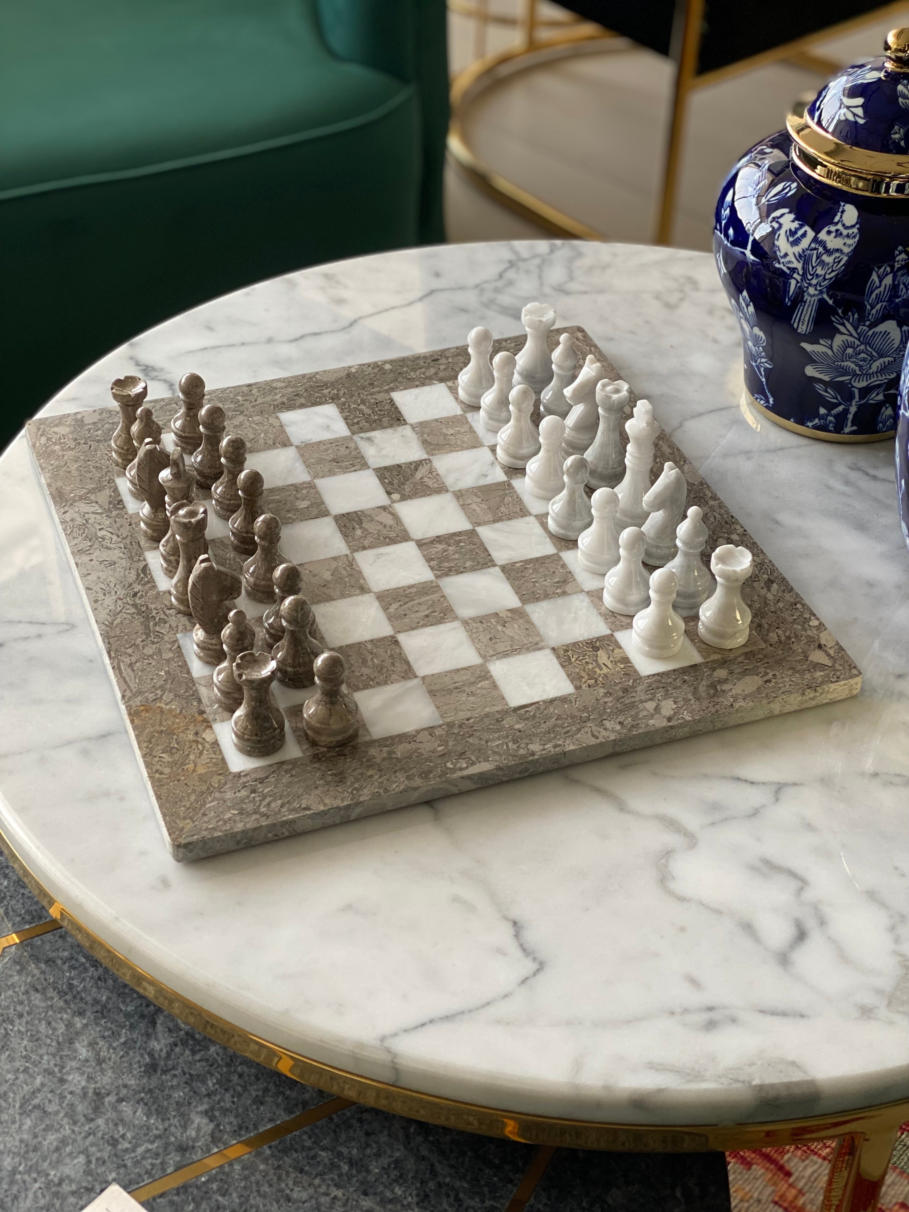 Chessboard with pieces on a marble table