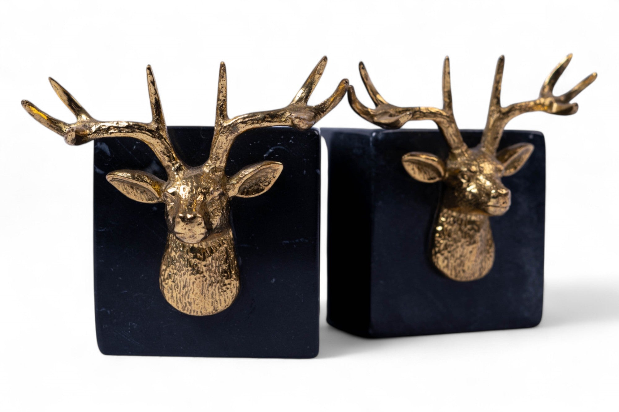 Two decorative bookends with gold deer heads on black bases.