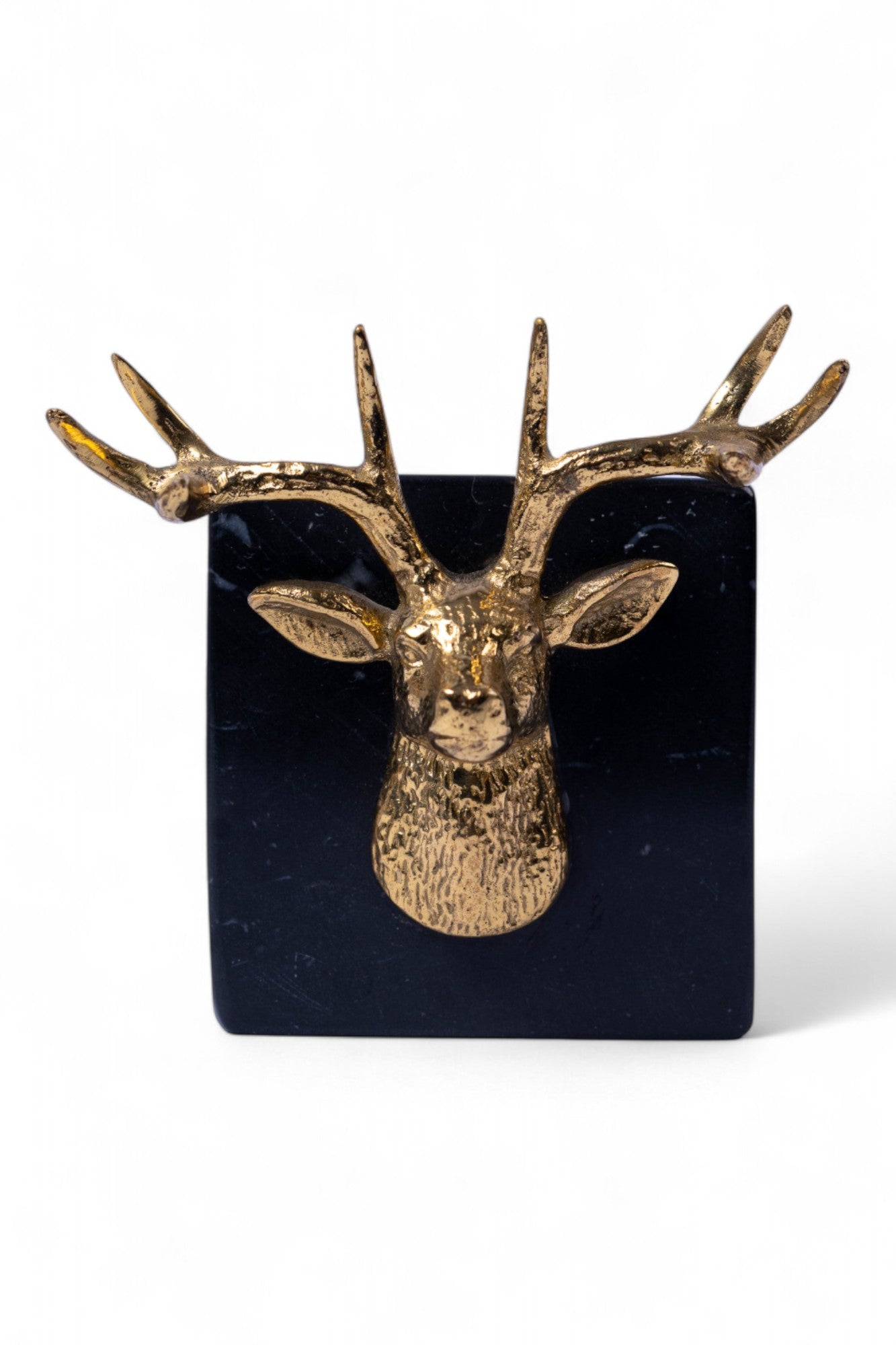 Gold deer head wall decoration on a black square background