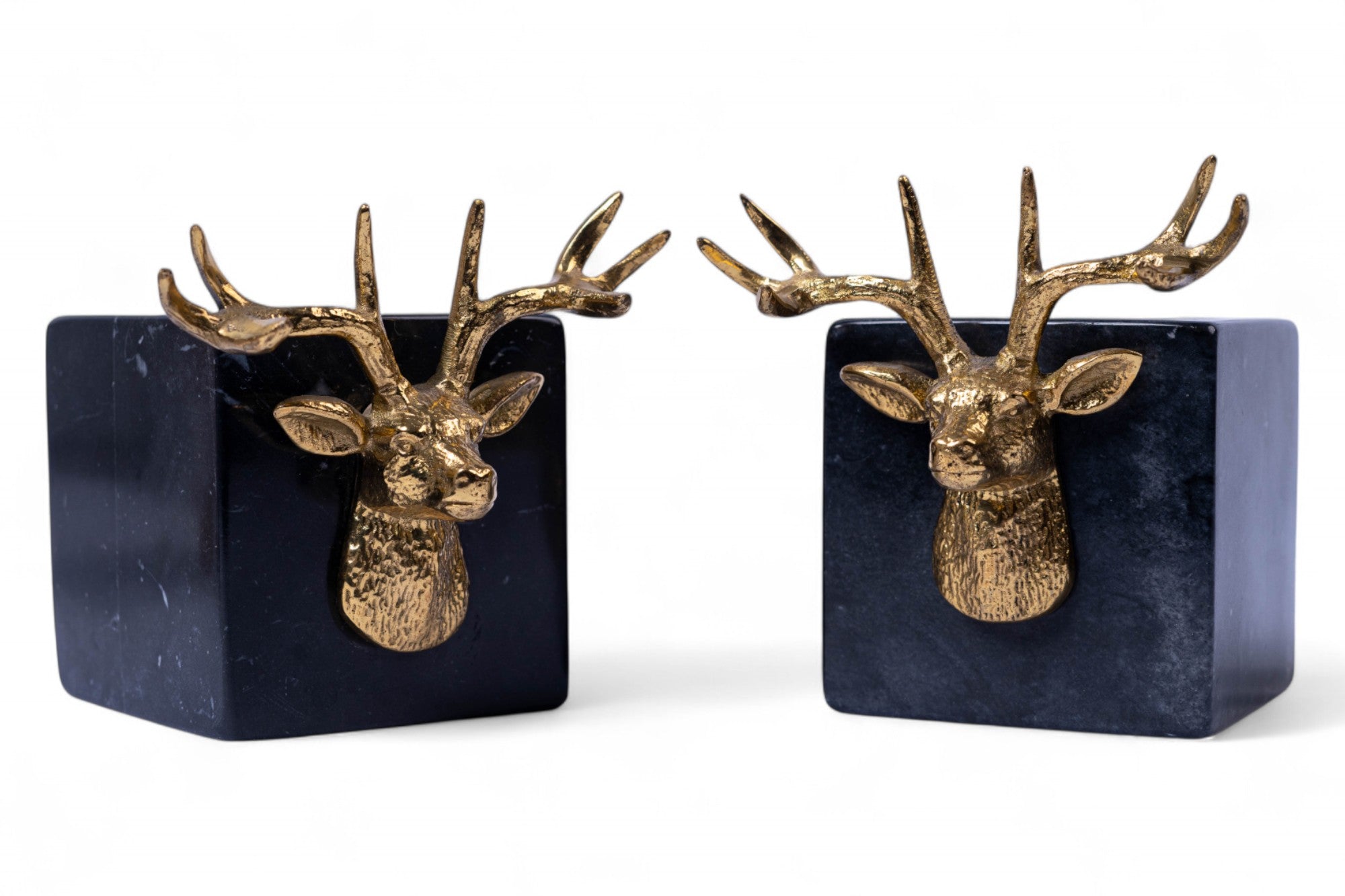 Two gold deer head bookends on a white background