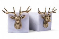 Two gold deer head bookends on a white background