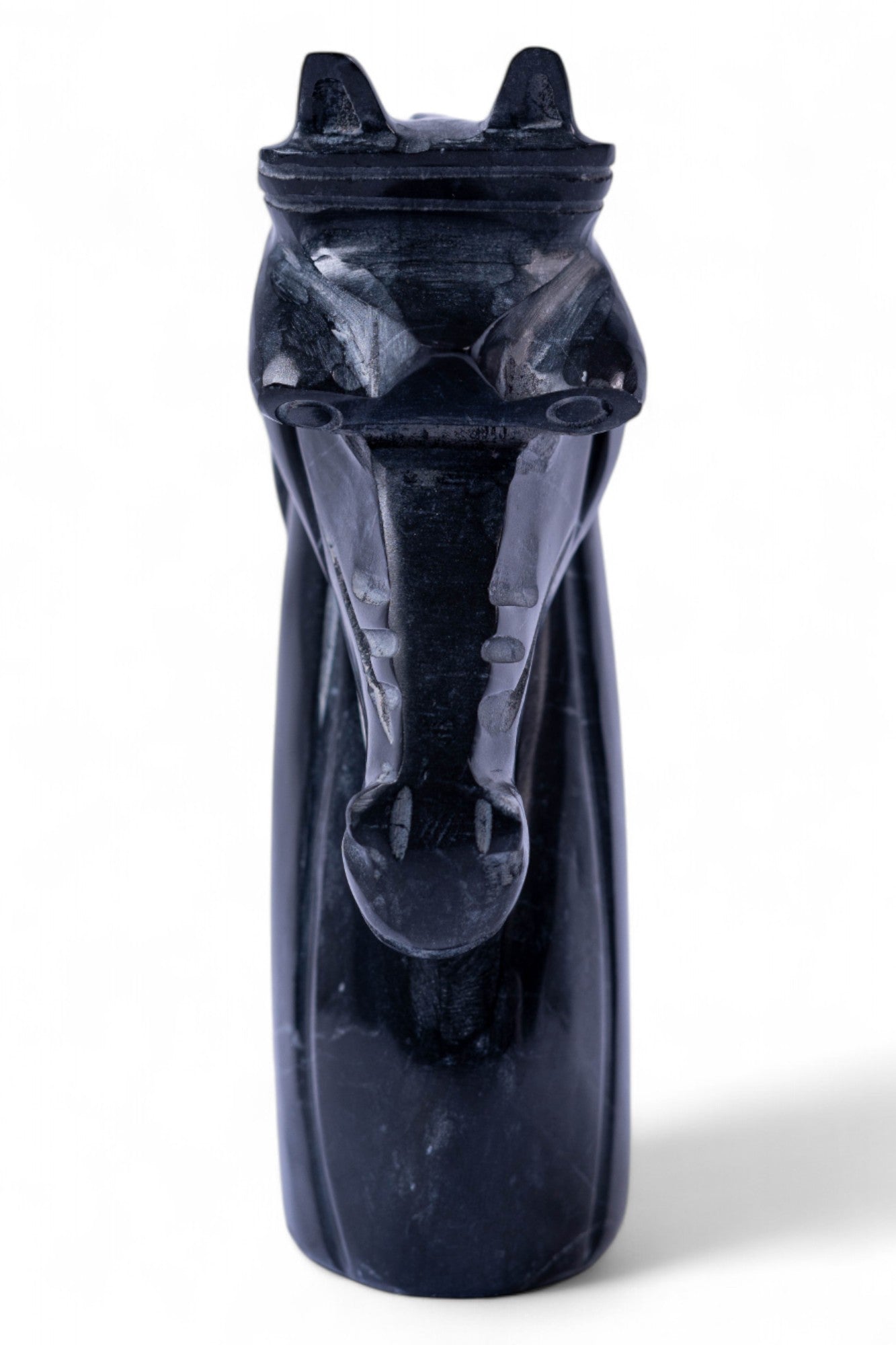 Black stone sculpture of a zebra on a white background