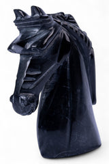 Black dragon head sculpture on a white background