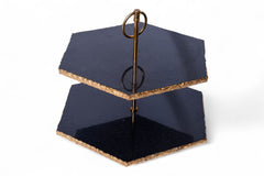 Two-tiered black stand with a decorative element on a white background