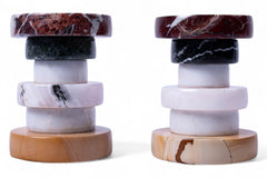 Two marble coasters with wooden bases on a white background