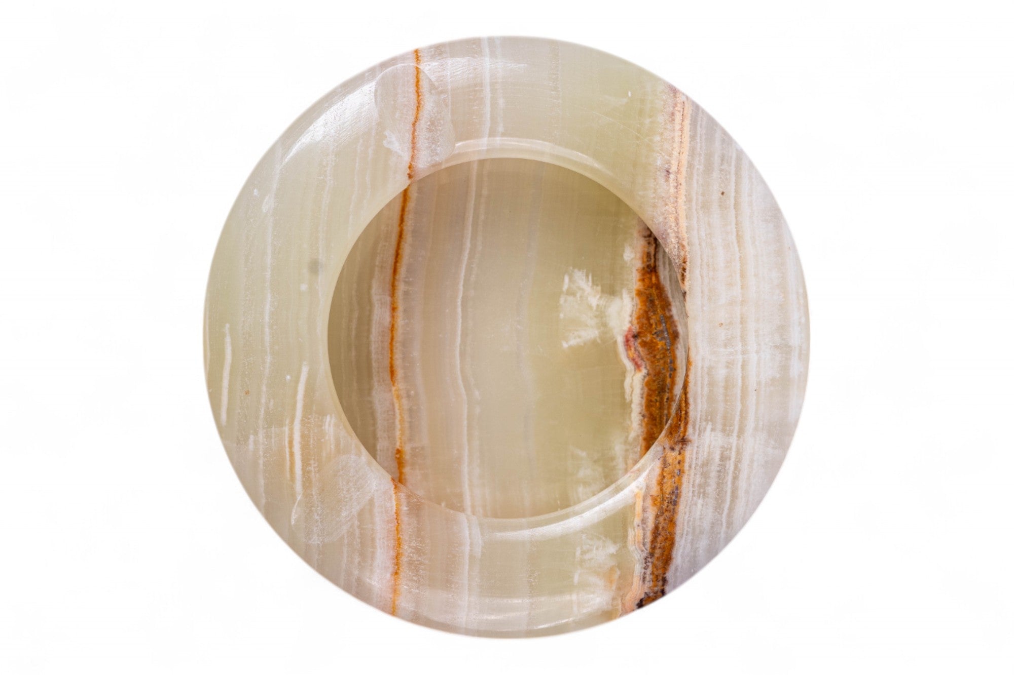 Round stone with concentric circular patterns on a white background