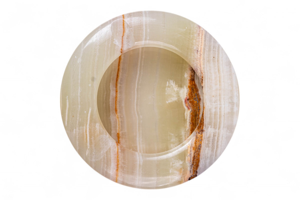 Round stone with concentric circular patterns on a white background