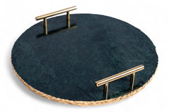 Round dark stone tray with gold handles on a white background