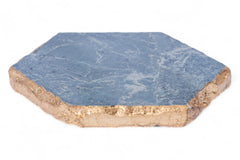 Hexagonal blue stone coaster with gold edge on a white background