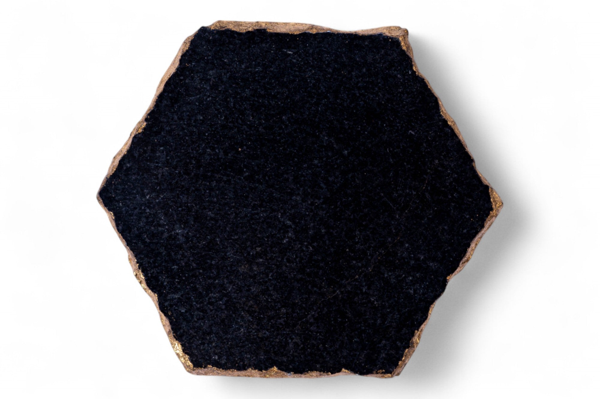 Hexagonal black tile with a brown border on a white background
