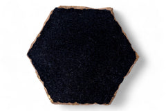 Hexagonal black tile with a brown border on a white background