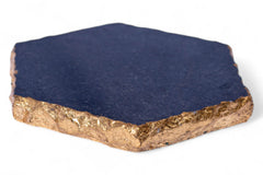 Hexagonal stone with gold base and blue top on a white background