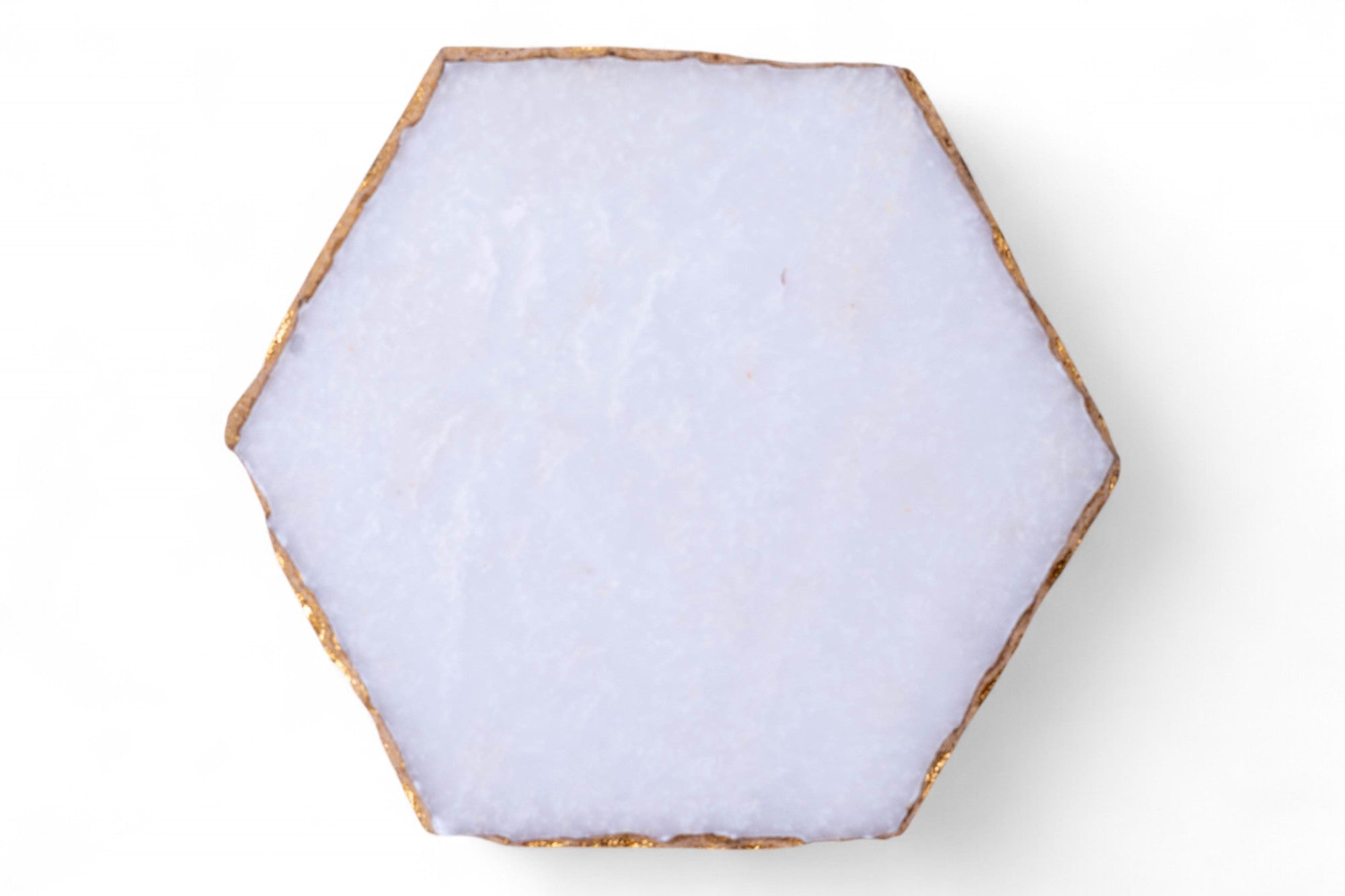 Hexagonal white stone coaster on a white background