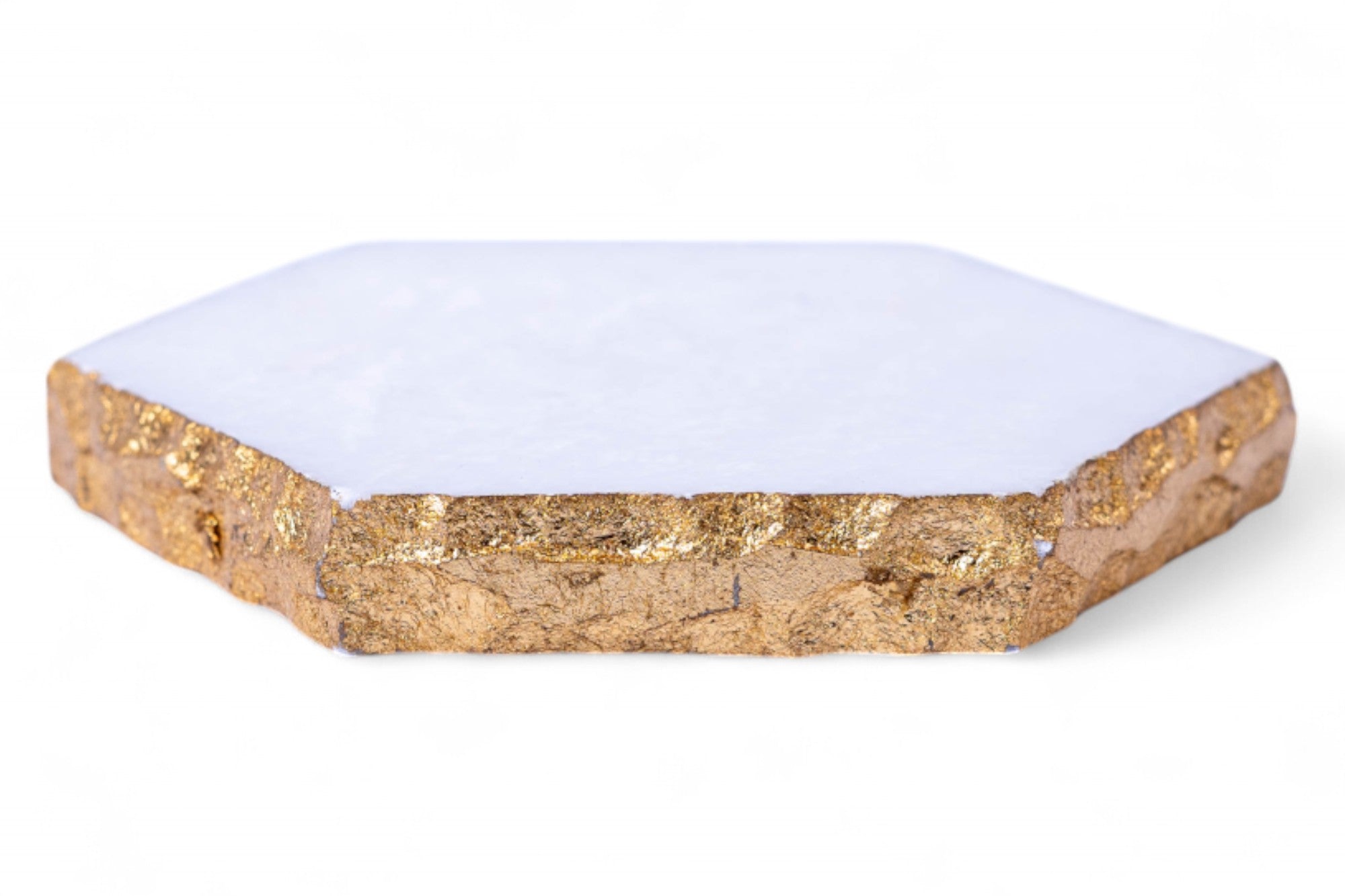 Hexagonal white coaster with gold edge on a white background