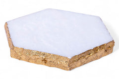 Hexagonal pet bed with white cushion and gold trim on a white background