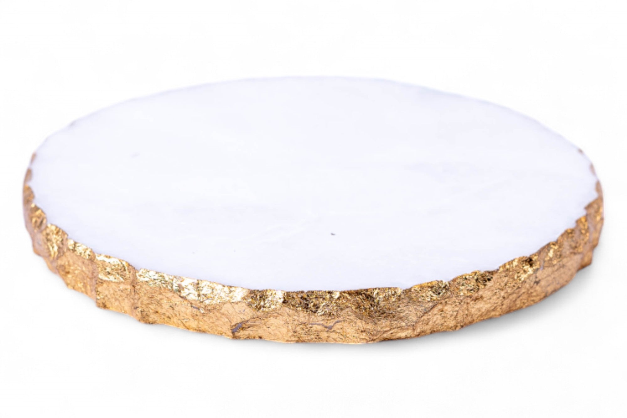 Round coaster with white center and gold rim on a white background