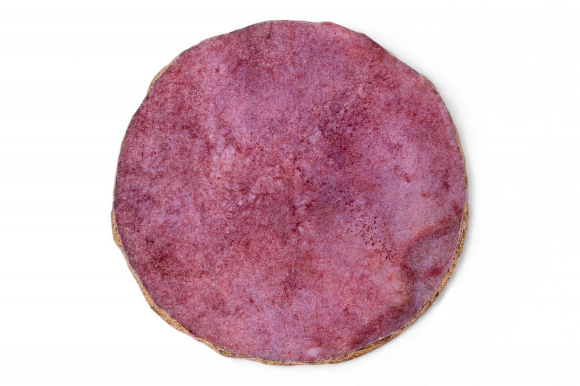 Round pinkish-brown cookie on a white background