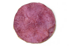 Round pinkish-brown cookie on a white background