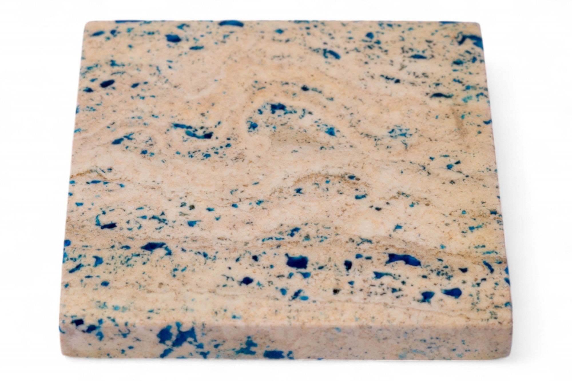 Square sponge with blue speckles on a white background