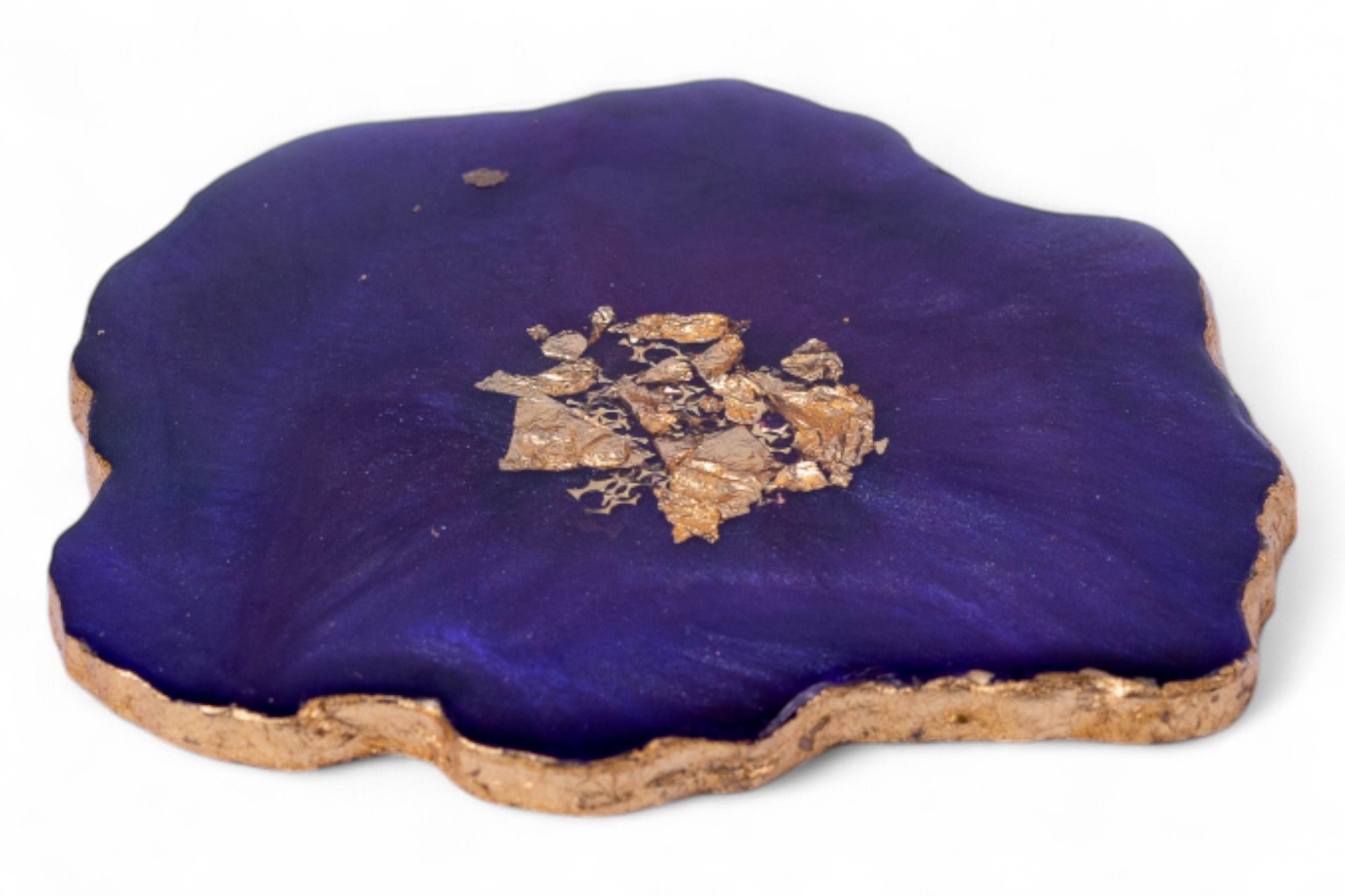 Geode with purple crystal and gold-colored mineral on a white background