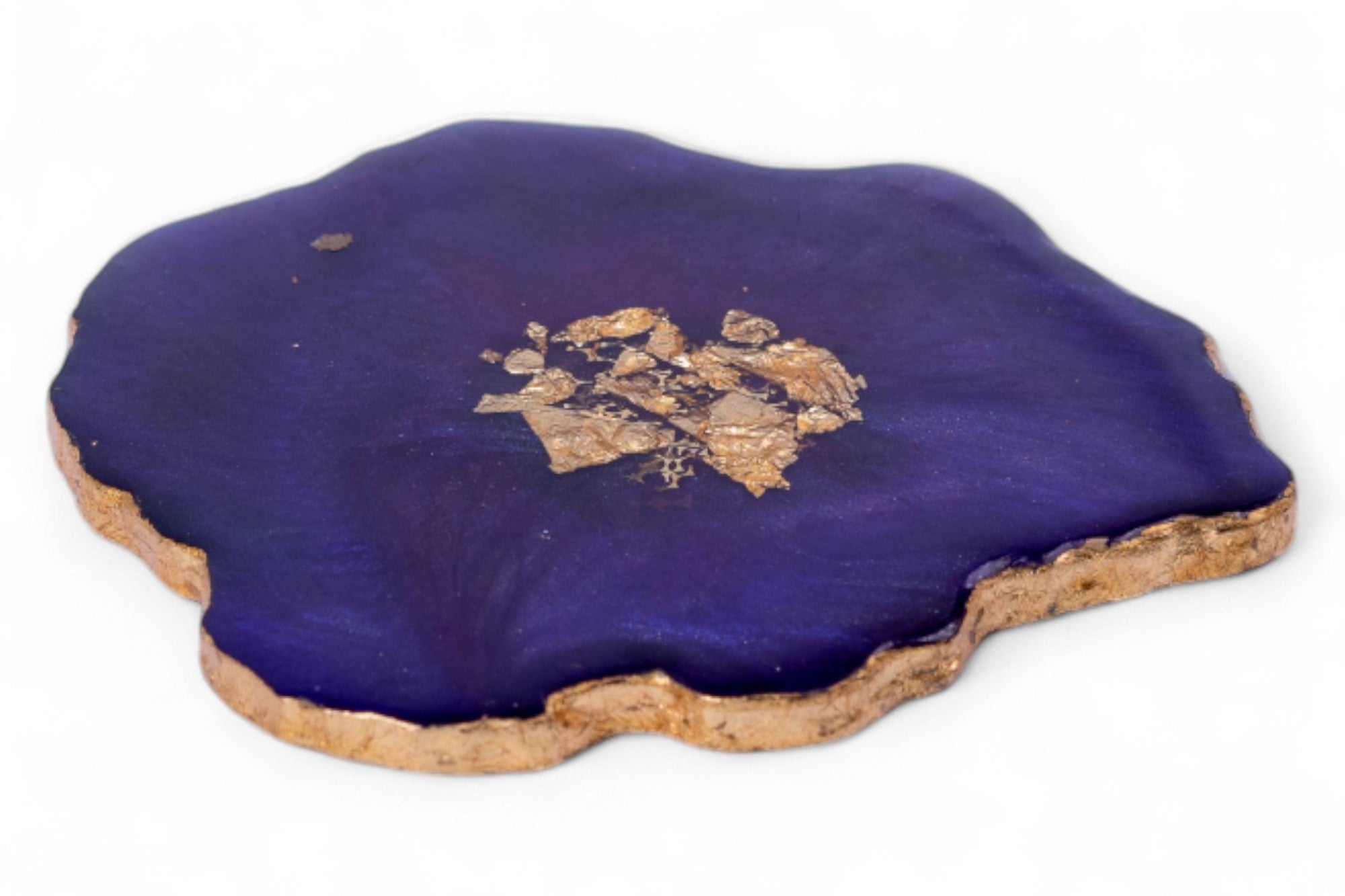 Purple cushion with a gold emblem on a white background
