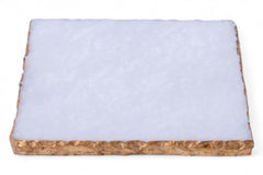 Rectangular piece of material with a white top layer and brown bottom layer on a white background