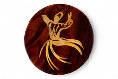 Wooden coaster with a gold deer antler design on a white background