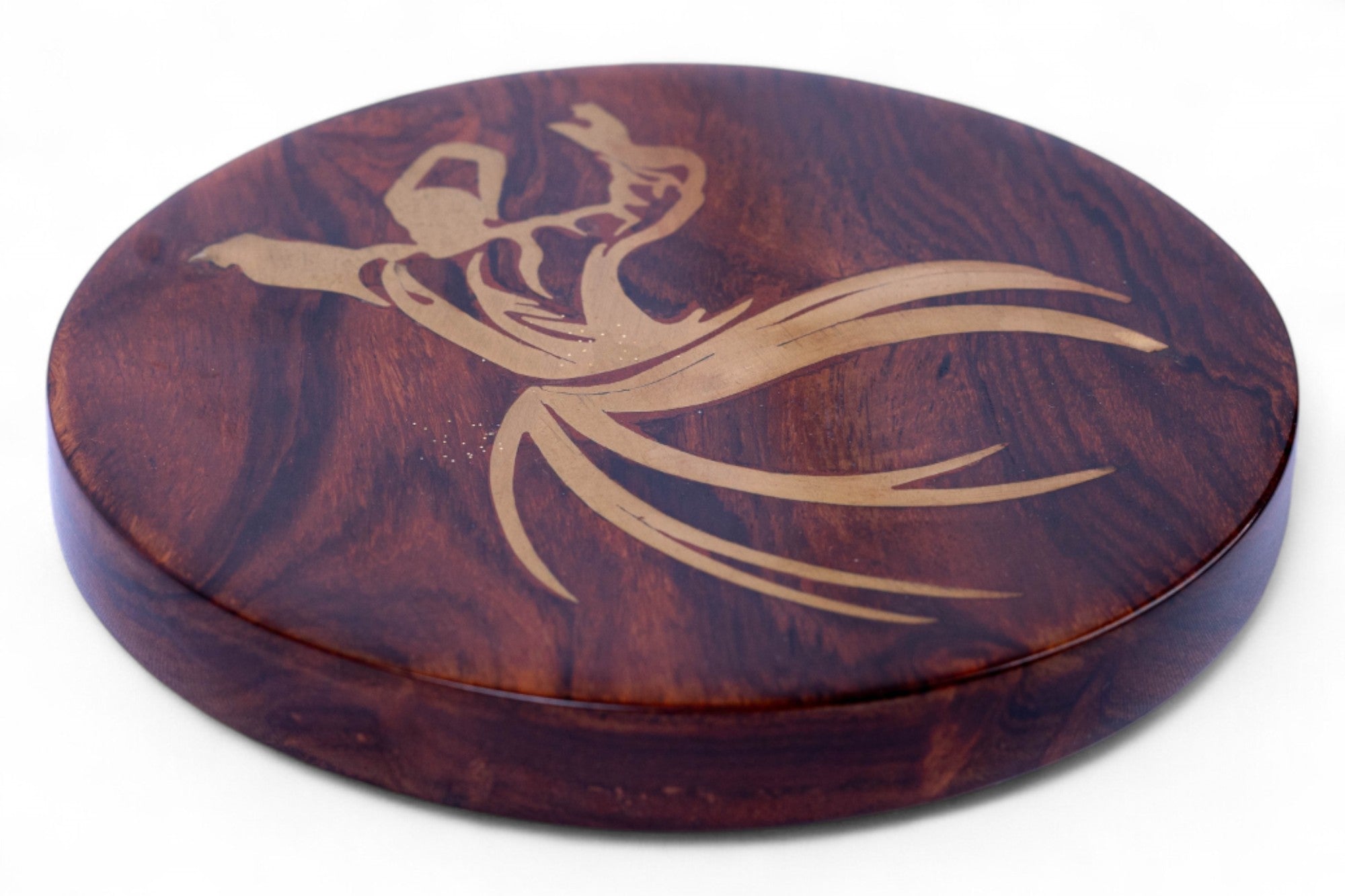 Wooden coaster with a gold leaf design on a white background