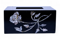 Black tissue box cover with floral design on a white background