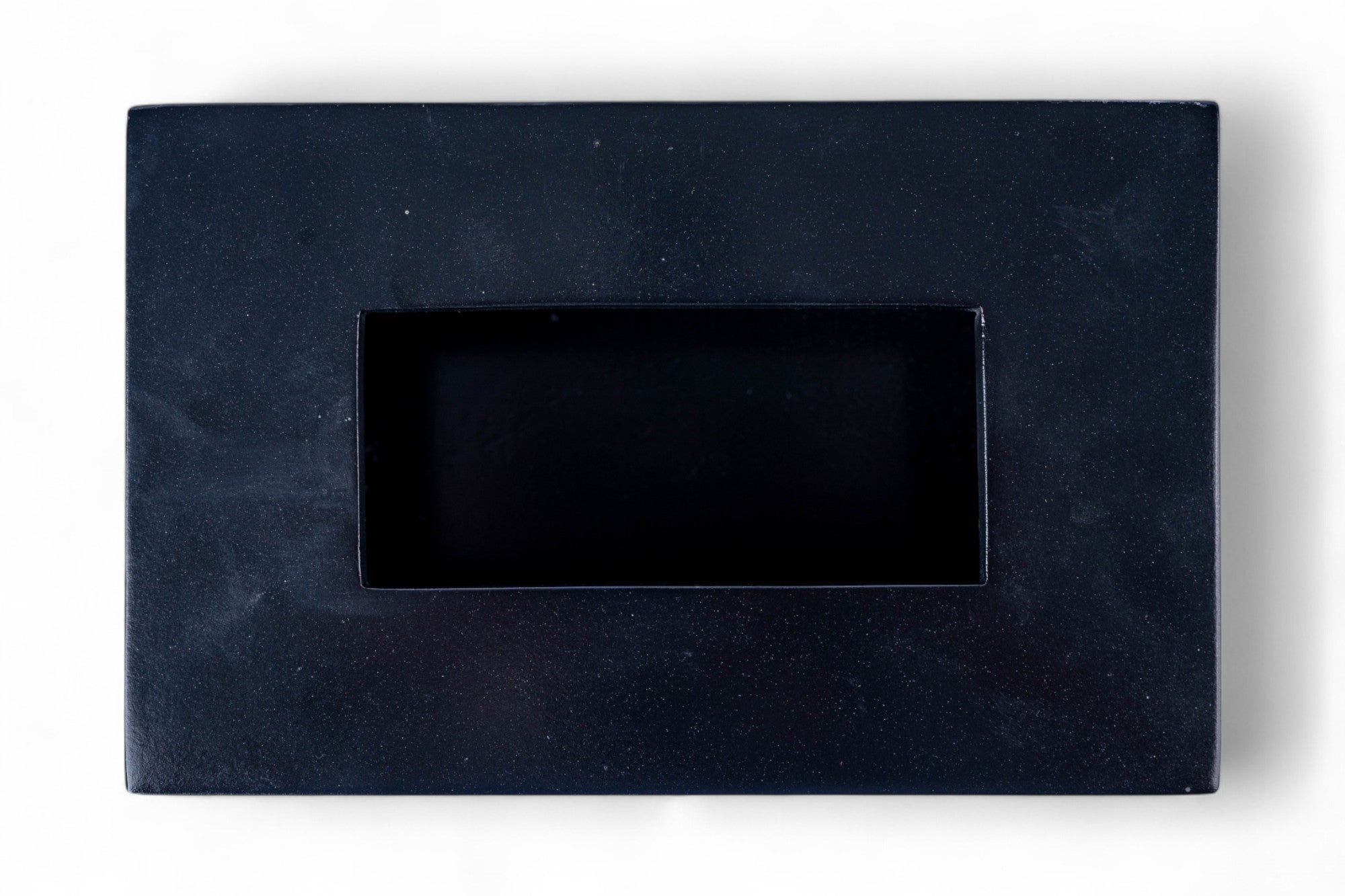 Black rectangular stone with a smaller central rectangle on a white background