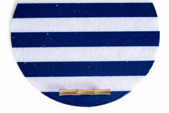 Round blue and white striped clutch with a gold clasp on a white background