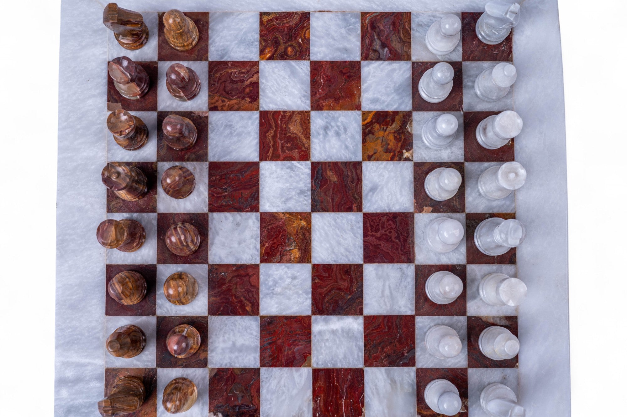Marble chessboard with wooden and white chess pieces on a marble surface