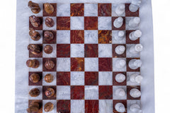 Marble chessboard with wooden and white chess pieces on a marble surface