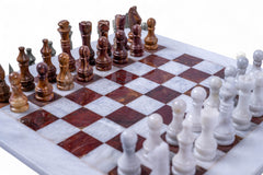 Marble chessboard with wooden and white chess pieces on a white background