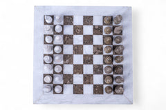 Marble chessboard with stone pieces on a white background