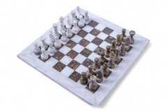 Marble chessboard with chess pieces on a white background
