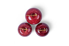 Three red cherry-shaped earrings with gold clasps on a white background
