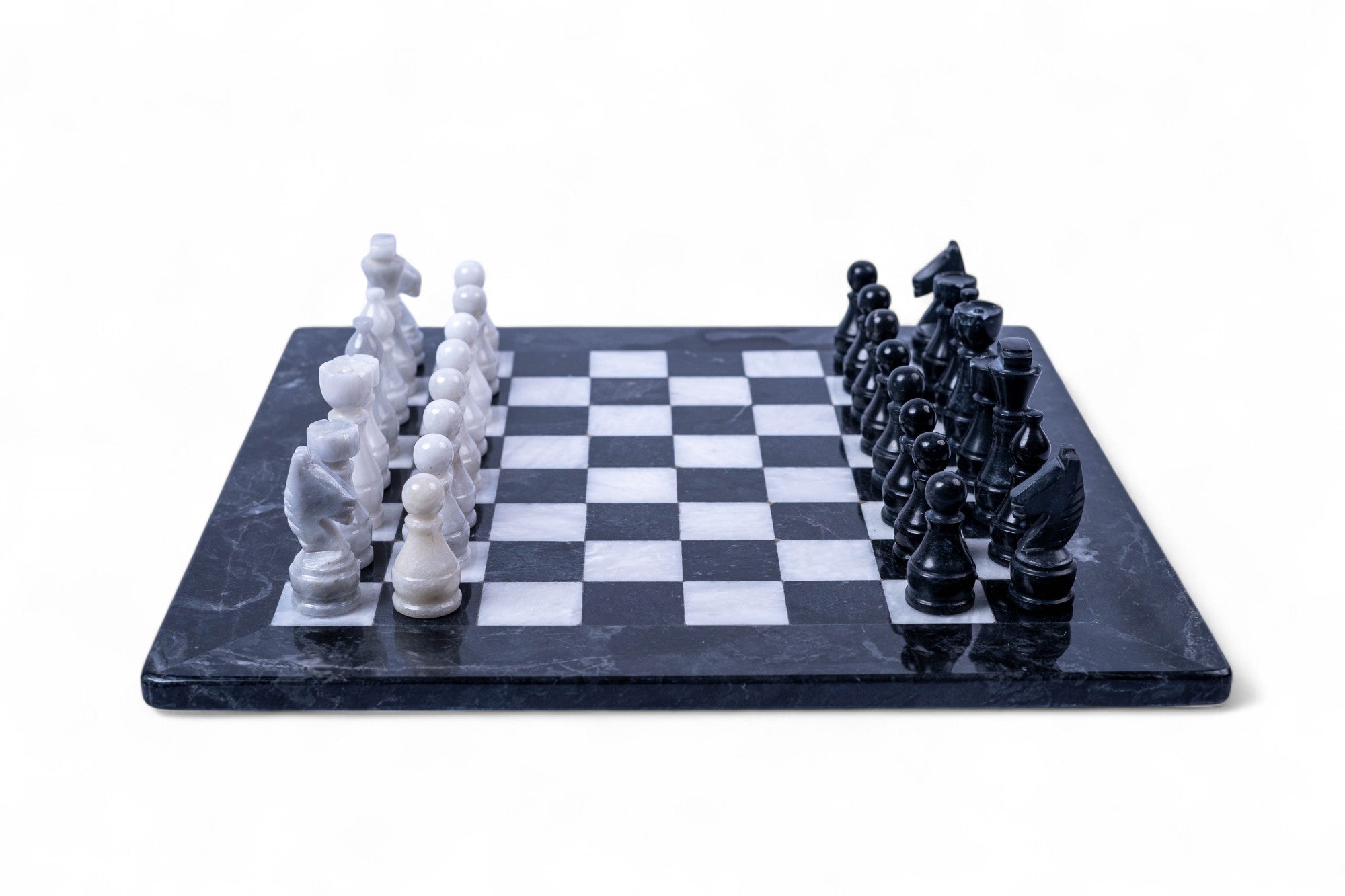 Black and white chess pieces on a checkered board