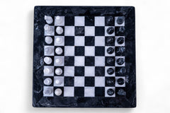 Marble chess board with pieces on a white background